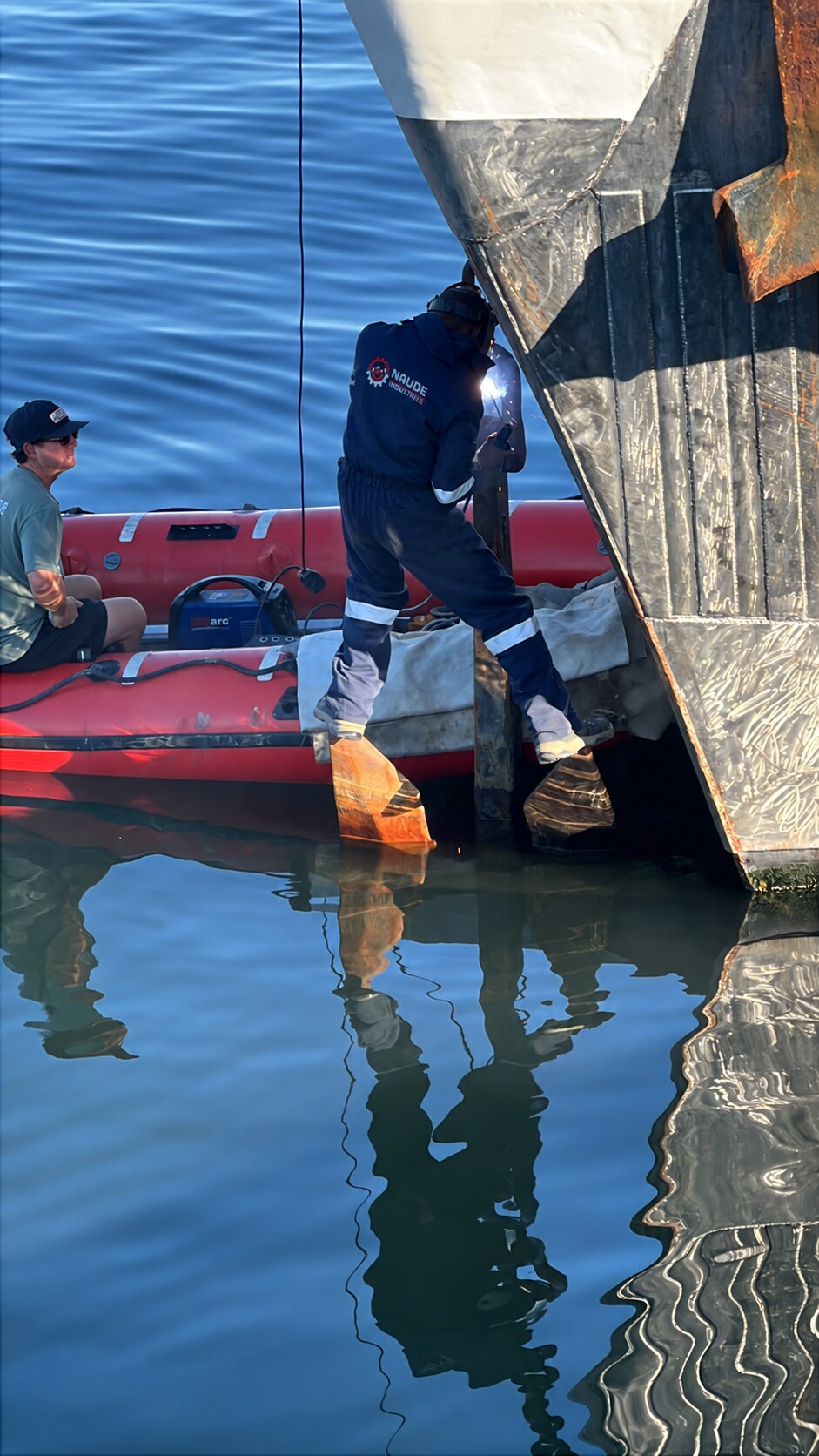 Naude Industries welder completing a live repair to a vessel anchor connection from an inflatable workboat