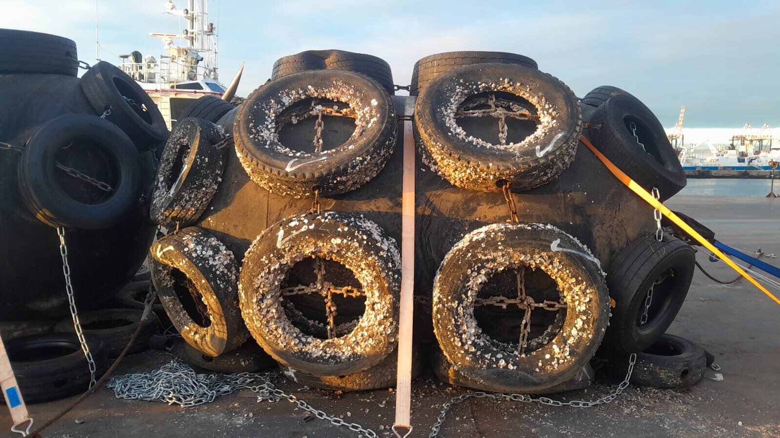 Severely worn and damaged tyres on marine fender units
