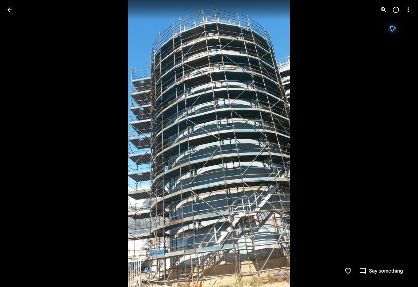 Large industrial storage tanks surrounded by access scaffolding