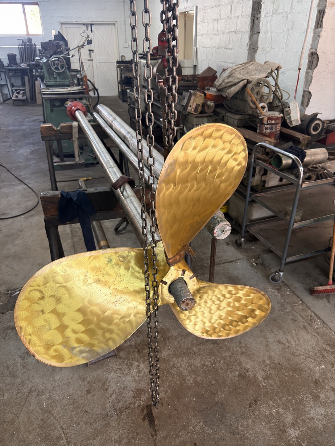 Vessel propeller handled during workshop inspection and fitting