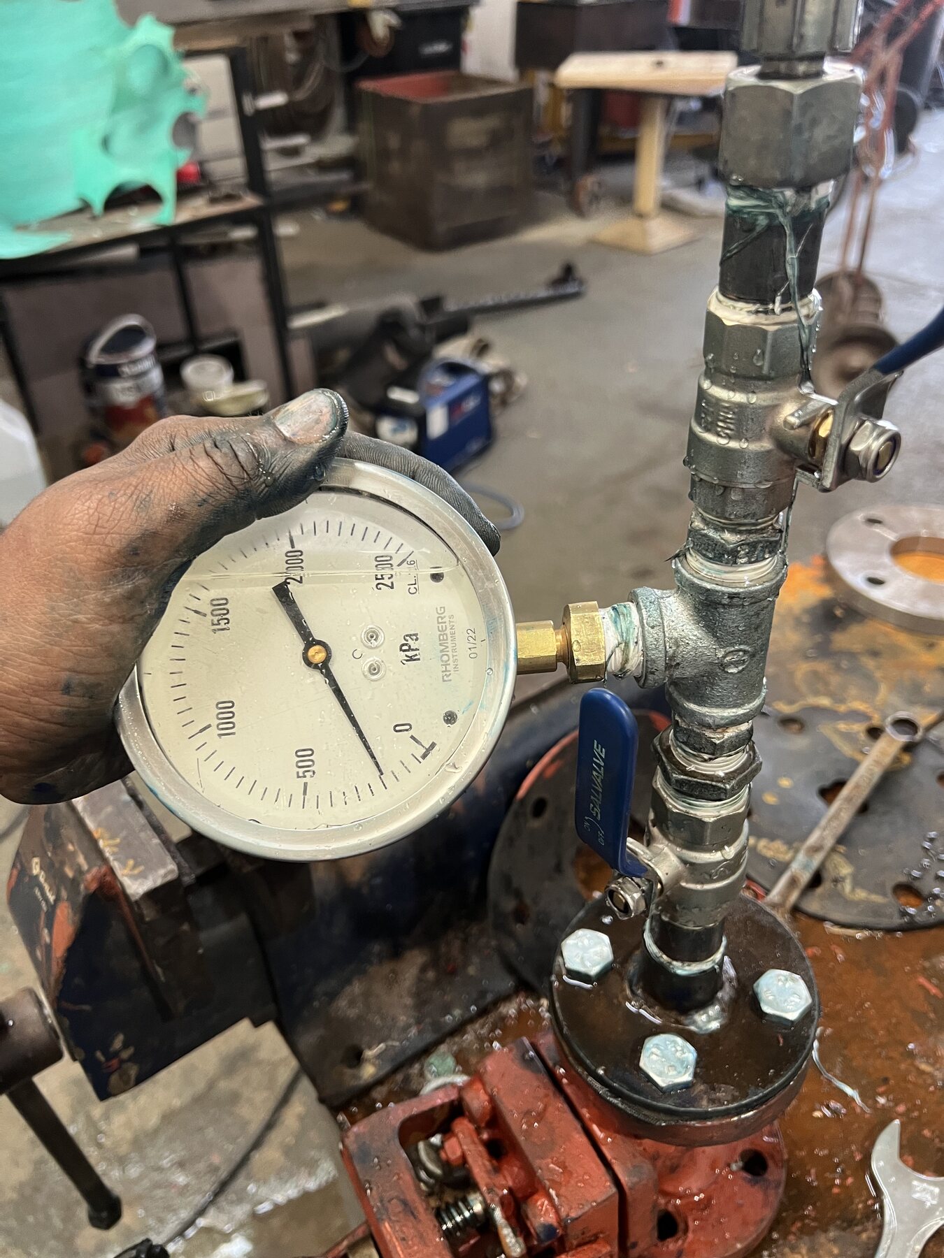 Technician monitoring a valve pressure test in the Naude Industries workshop