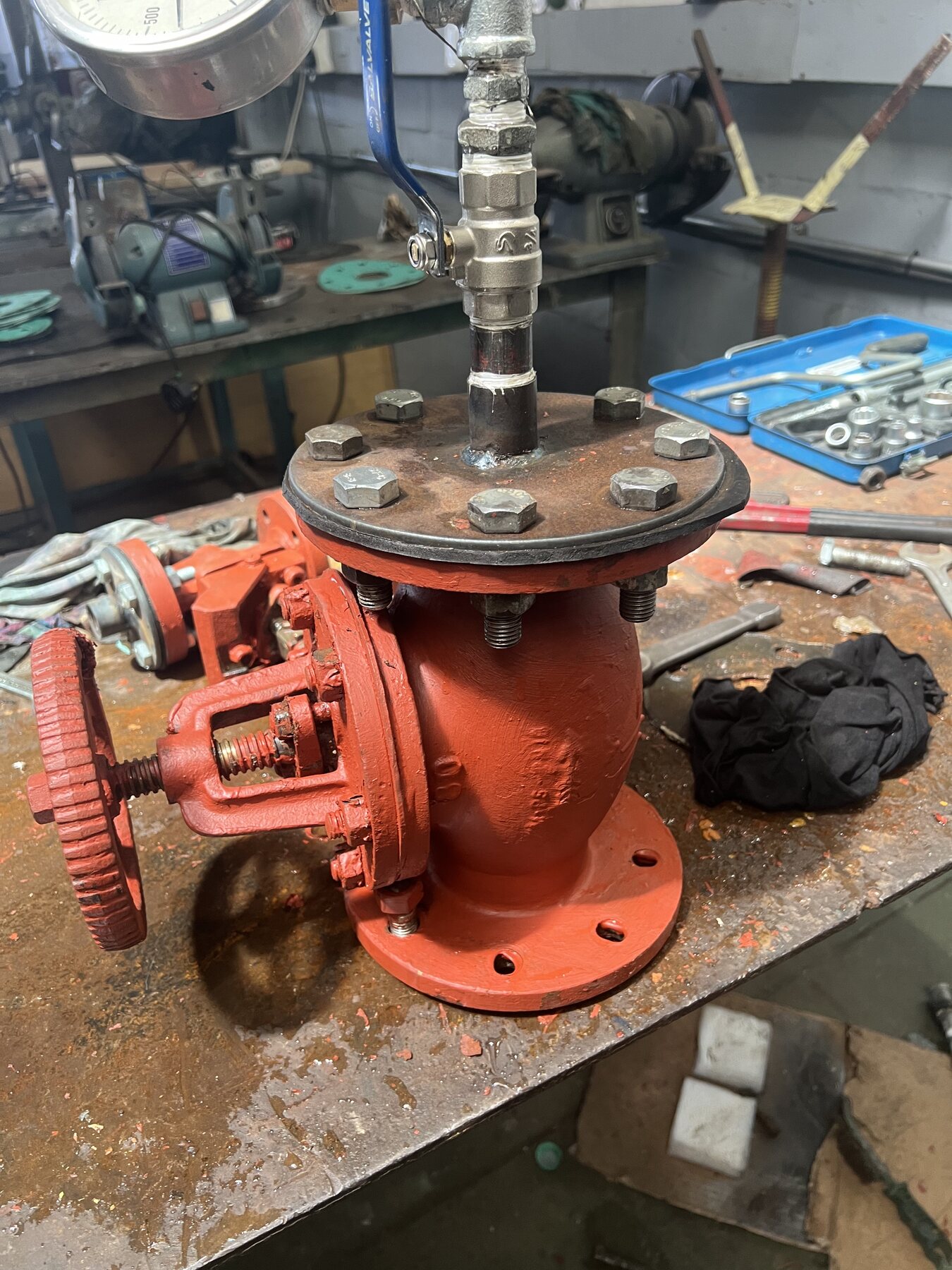 Complete marine valve connected to a pressure gauge for workshop testing